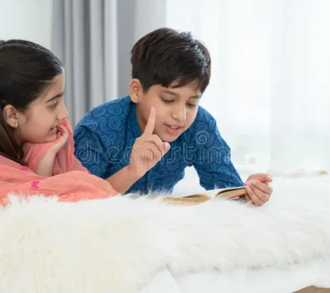 two-happy-indian-brother-sister-traditional-clothing-lying-bed-reading-book-having-fun-together-home-education-249891970